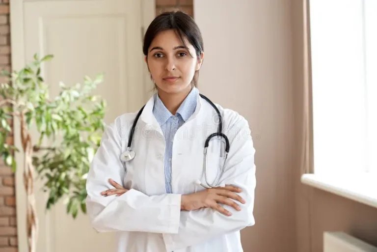 confident-young-adult-indian-female-doctor-gp-wear-white-coat-stethoscope-looking-camera-standing-arms-crossed-medical-191740547